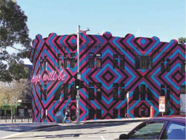 Image of building painted in pink, blue and black pattern.