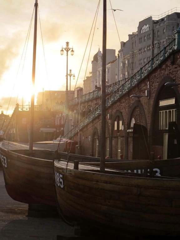 photograph of boats in harbour at dawn