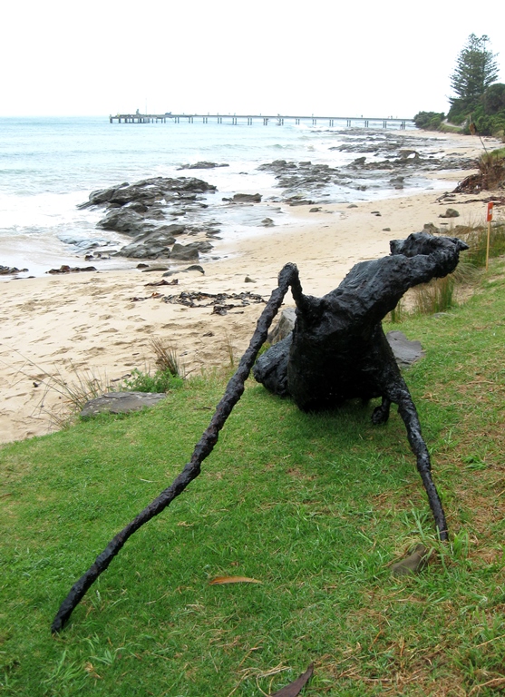 Stylised horse lying on a beach